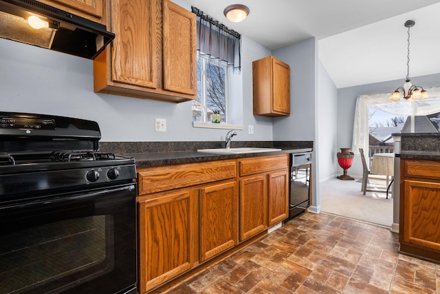 kitchen featuring ventilation hood, dark countertops, a sink, and black appliances