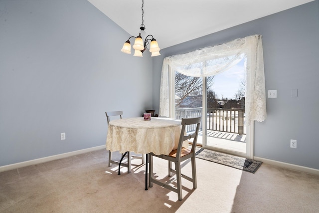 dining room featuring baseboards, vaulted ceiling, a notable chandelier, and light colored carpet