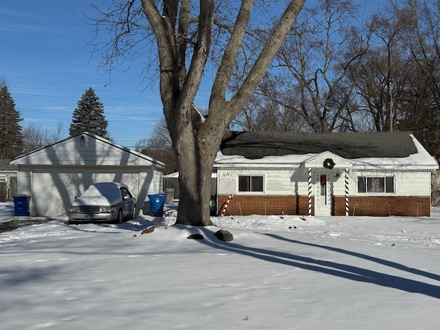 view of front of house featuring brick siding and a detached garage