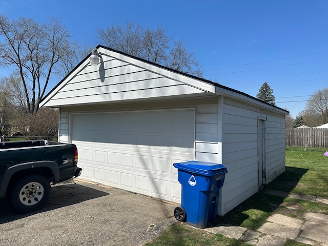 detached garage featuring fence