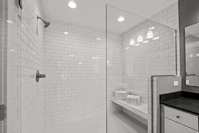 full bath with recessed lighting, vanity, and a walk in shower
