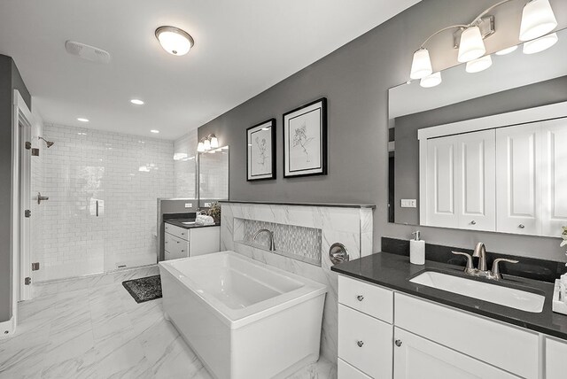 bathroom featuring a stall shower, a sink, marble finish floor, two vanities, and recessed lighting