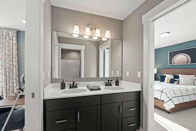 ensuite bathroom featuring a sink, double vanity, connected bathroom, and a shower stall