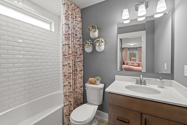 bathroom featuring toilet, shower / bath combo with shower curtain, and vanity