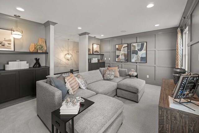 living room with recessed lighting, light carpet, and a decorative wall