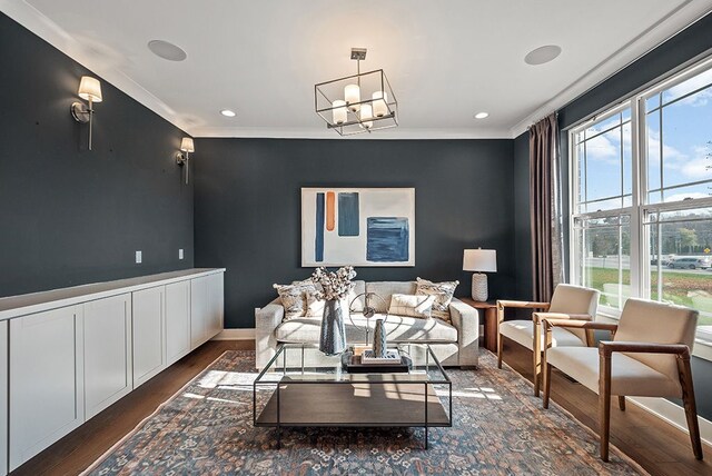 living room featuring dark wood-style floors, a chandelier, crown molding, and recessed lighting