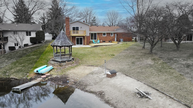 view of yard featuring a gazebo, a water view, and driveway