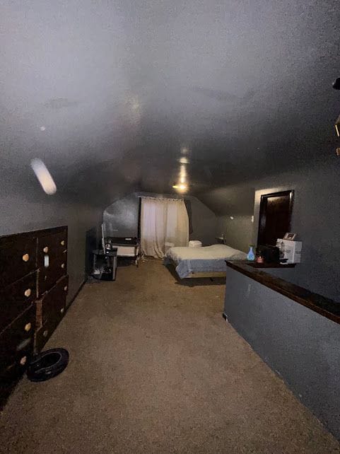 bedroom with carpet, mail area, and a textured ceiling