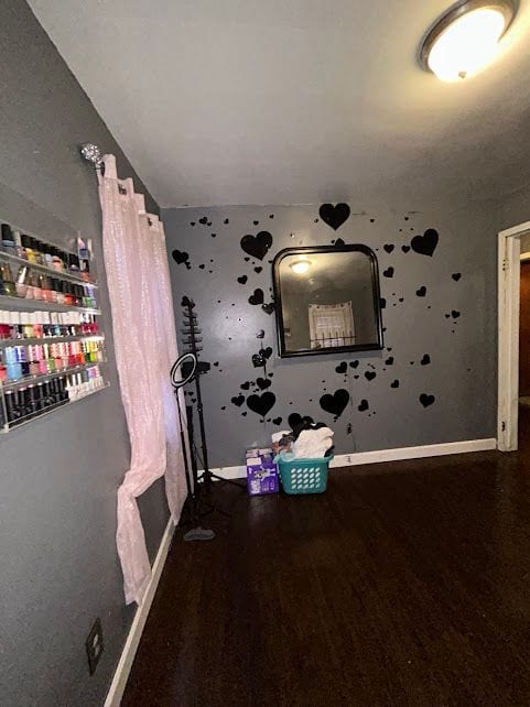 interior space with dark wood-style floors and baseboards