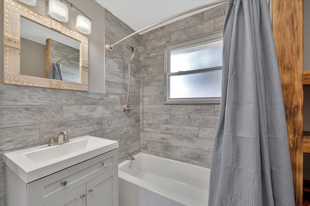 bathroom with shower / bath combination with curtain, tile walls, vanity, and tasteful backsplash