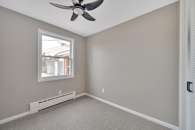 carpeted spare room with a ceiling fan, baseboards, and baseboard heating