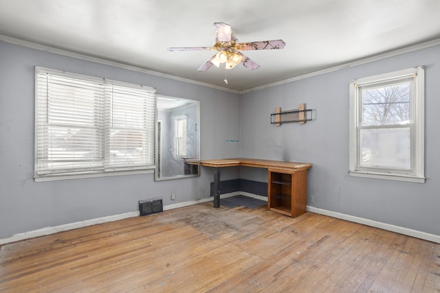 home office featuring visible vents, hardwood / wood-style floors, ornamental molding, a ceiling fan, and baseboards