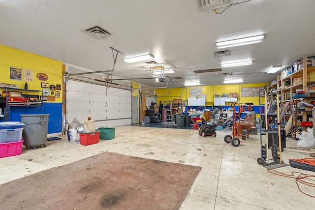 garage featuring visible vents and a garage door opener