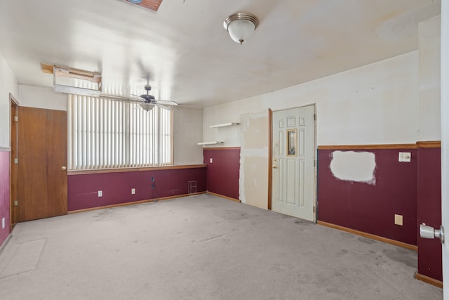 carpeted spare room with ceiling fan and visible vents