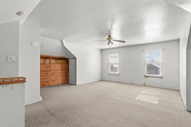 bonus room with carpet floors and ceiling fan