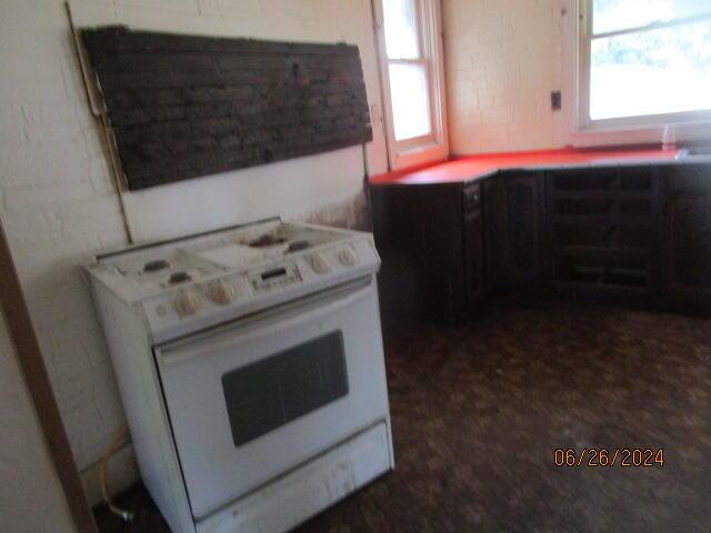 kitchen with white stove and plenty of natural light