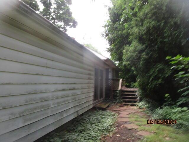 view of home's exterior featuring stairway