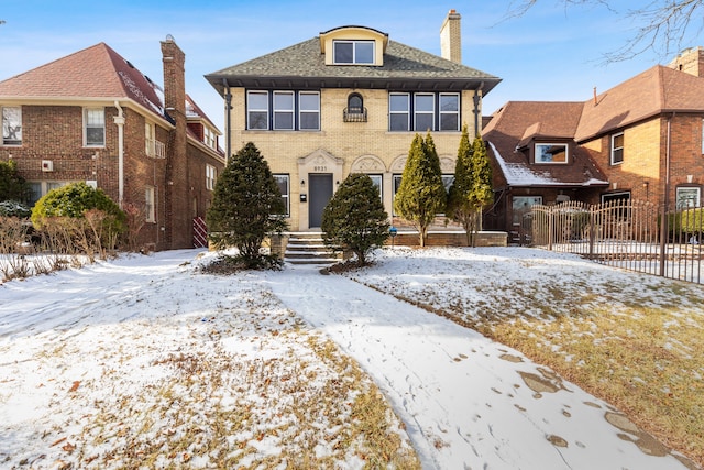 view of front of home with fence and brick siding