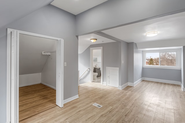 interior space with light wood-style flooring, visible vents, and baseboards