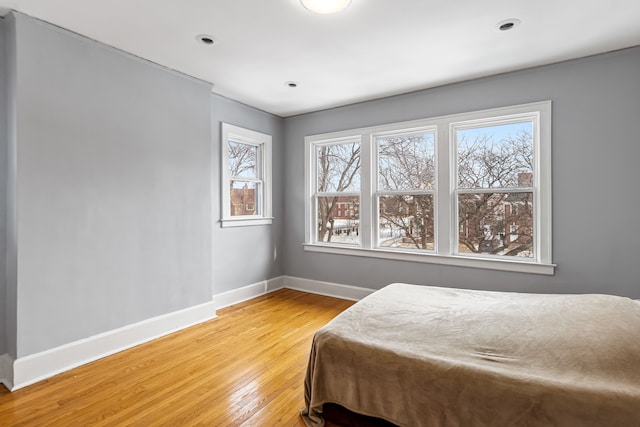 bedroom featuring baseboards and wood finished floors