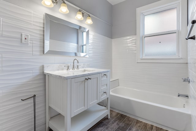 full bathroom with wood finished floors, vanity, and a healthy amount of sunlight