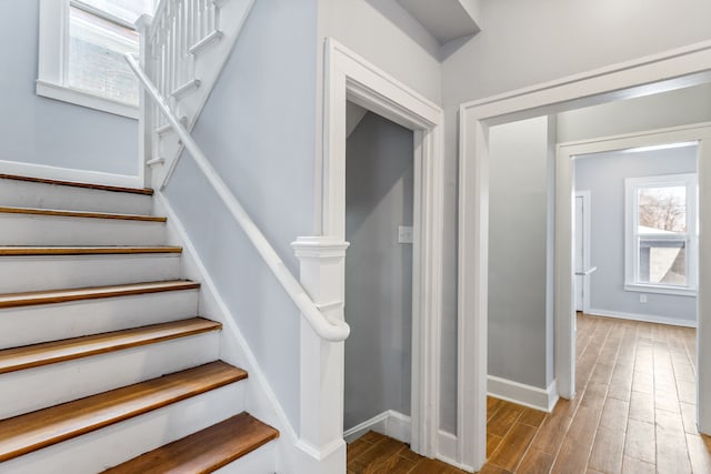 stairs with baseboards and wood finished floors