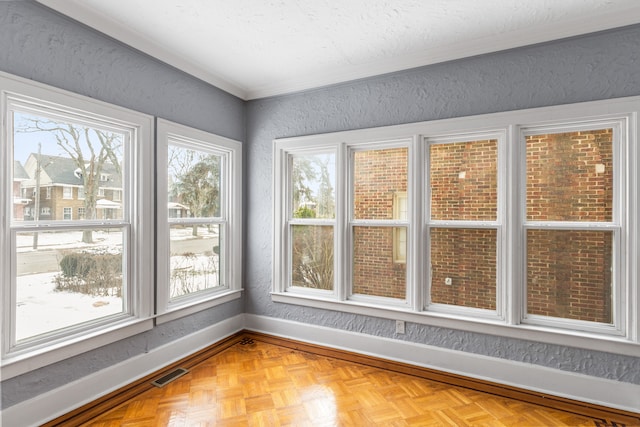 unfurnished sunroom featuring visible vents and a wealth of natural light