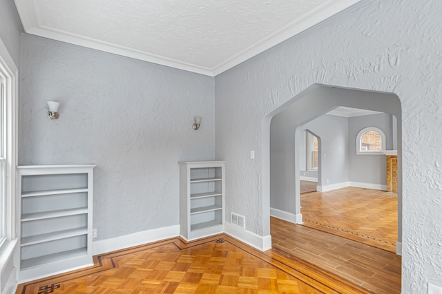 spare room with a textured wall and visible vents