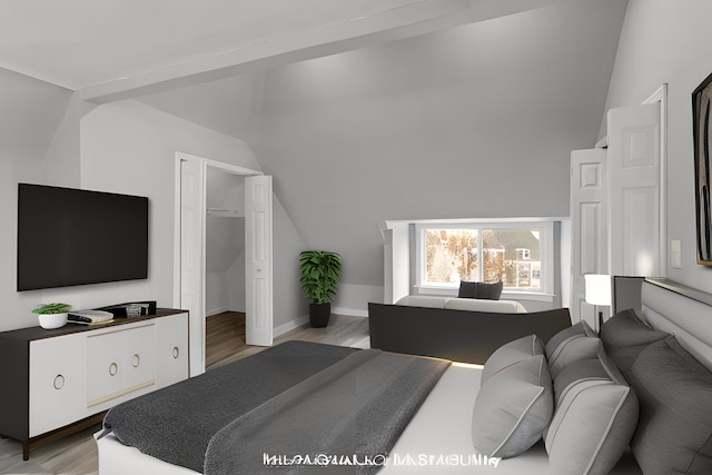 bedroom with light wood-style flooring, baseboards, vaulted ceiling, and a closet