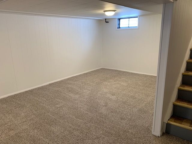 basement with carpet floors and stairway