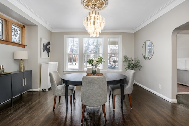 dining space featuring crown molding, arched walkways, dark wood finished floors, and baseboards