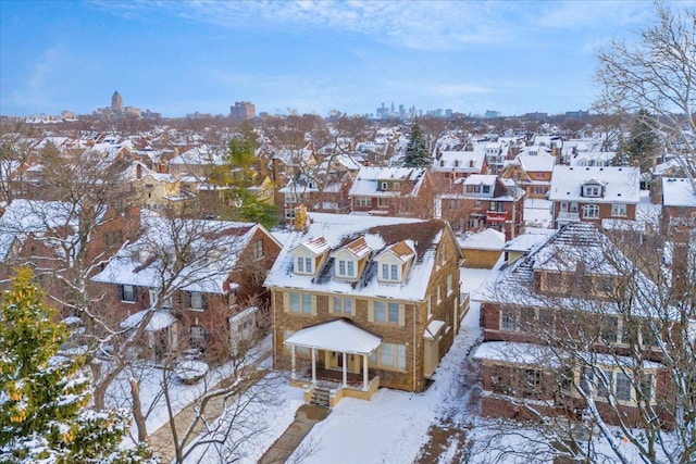 snowy aerial view with a residential view