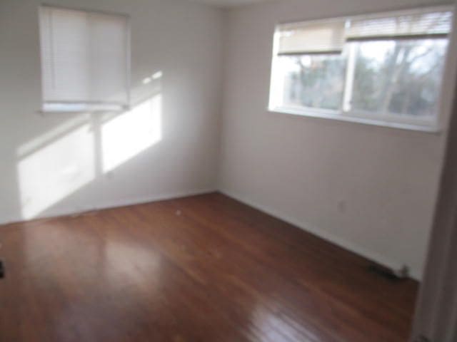 empty room with dark wood-style floors