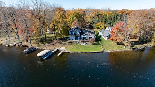 drone / aerial view with a water view and a wooded view