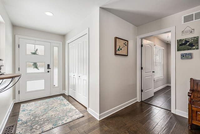 foyer entrance with recessed lighting, visible vents, baseboards, and dark wood-style floors