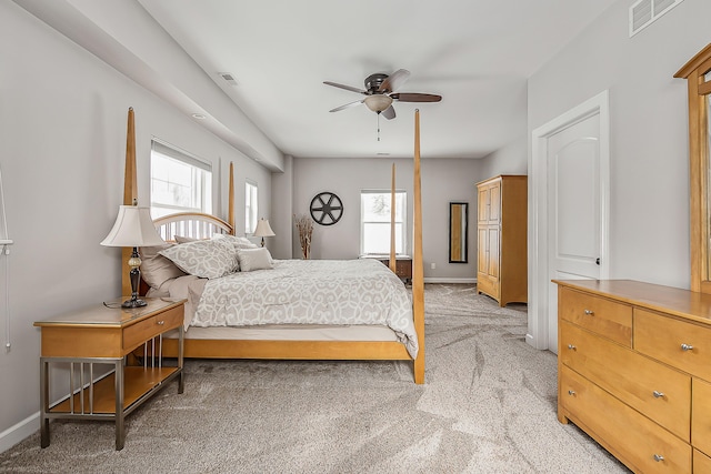 bedroom with light carpet, multiple windows, and visible vents