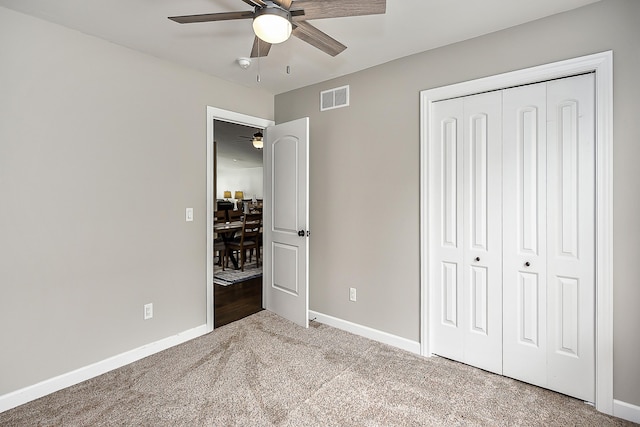 unfurnished bedroom with baseboards, visible vents, a closet, ceiling fan, and carpet floors