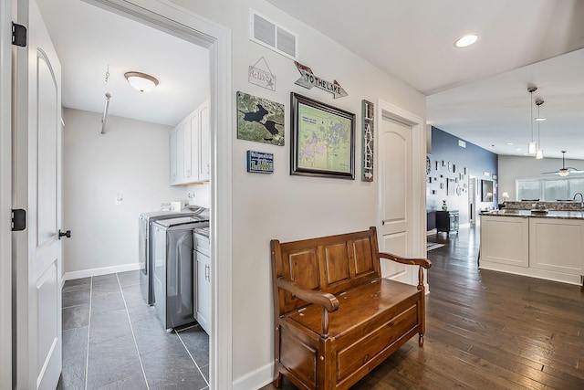 corridor with washer and dryer, baseboards, visible vents, and recessed lighting