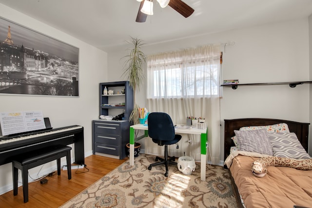 bedroom with baseboards, a ceiling fan, and wood finished floors