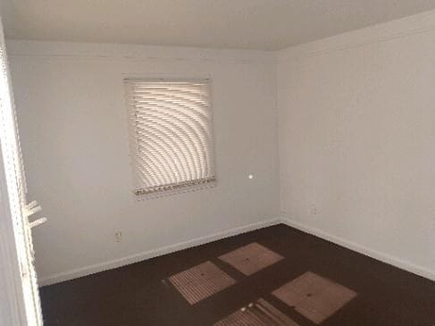 spare room featuring baseboards