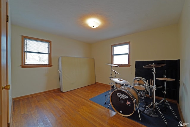 rec room featuring wood finished floors and baseboards