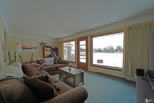 living room featuring carpet floors, baseboard heating, and plenty of natural light