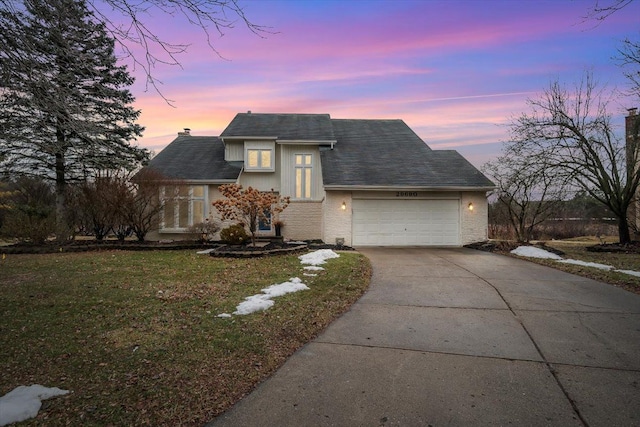 view of front of property featuring brick siding, a lawn, a chimney, a garage, and driveway