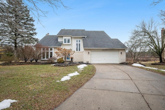 view of front of house with brick siding, a front lawn, a chimney, a garage, and driveway