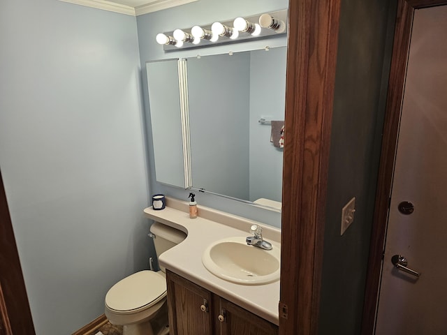 half bathroom with toilet, ornamental molding, and vanity