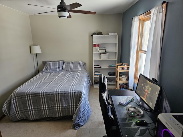 bedroom with light carpet and a ceiling fan