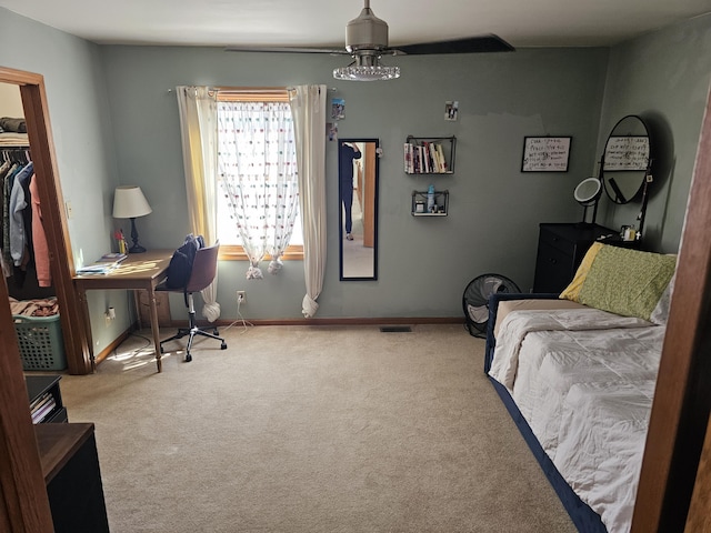 carpeted bedroom with ceiling fan, visible vents, and baseboards