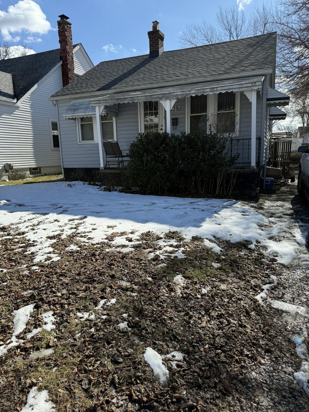 view of front of home featuring covered porch and roof with shingles