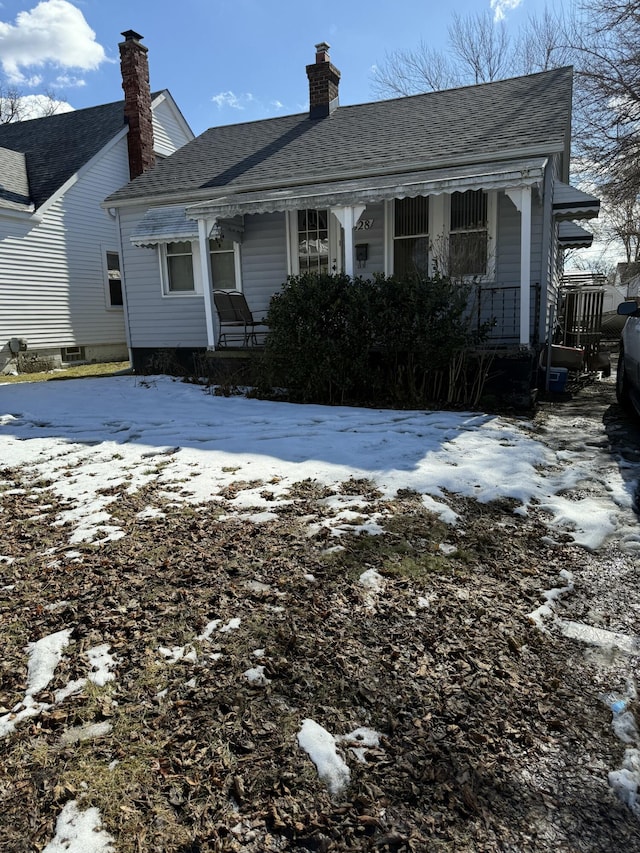 view of front of home featuring covered porch and roof with shingles