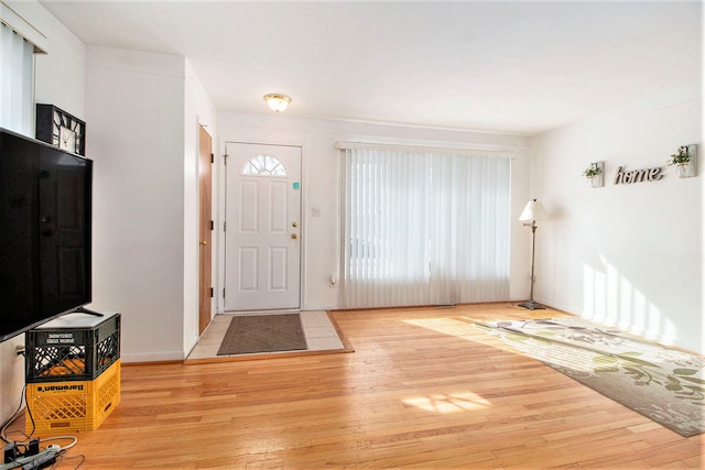 entrance foyer with light wood-style floors and baseboards